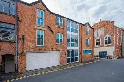 a large brick building with a white garage at Luxury stay in Central Southport in Southport