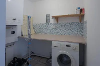 a laundry room with a washing machine and a counter at Luxury stay in Central Southport in Southport
