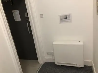 a white toilet in a bathroom with a door at Green-Lodge Triple Double & Single Rooms Near LFC Anfield Free Street Parking 24-7 in Liverpool