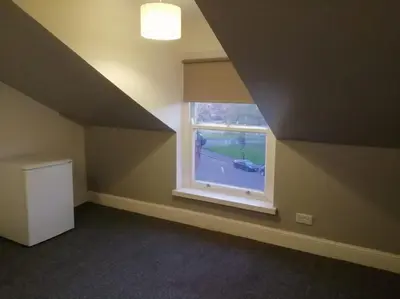 an empty room with a window in an attic at Green-Lodge Triple Double & Single Rooms Near LFC Anfield Free Street Parking 24-7 in Liverpool
