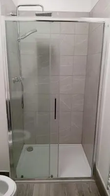 a shower with a glass door in a bathroom at Green-Lodge Triple Double & Single Rooms Near LFC Anfield Free Street Parking 24-7 in Liverpool