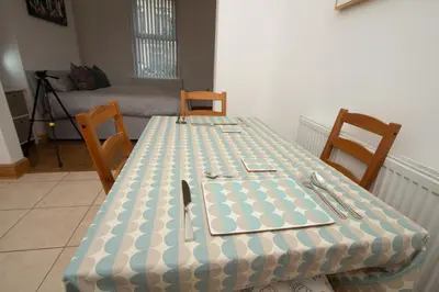 a table with a blue and white checkered table cloth at Cosy Studio Near Goodison & Anfield, Liverpool in Liverpool
