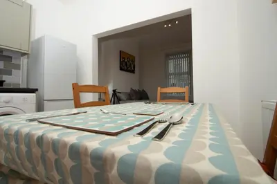 a table with utensils sitting on top of it at Cosy Studio Near Goodison & Anfield, Liverpool in Liverpool