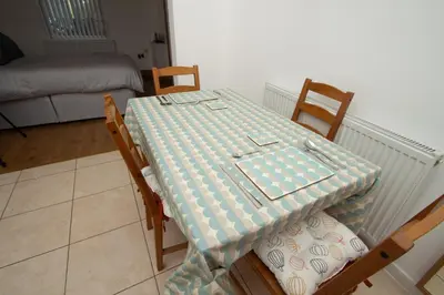 a table with a table cloth on it in a room at Cosy Studio Near Goodison & Anfield, Liverpool in Liverpool