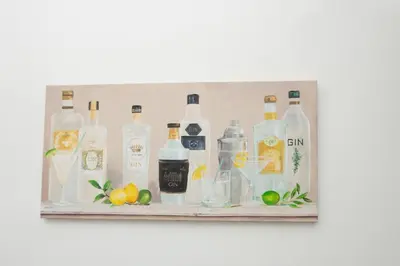 a shelf with bottles of alcohol and fruit on it at Cosy 2BR Flat Near Anfield & Goodison, Liverpool in Liverpool