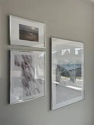 three pictures hanging on a wall in a room at Luxury 3 Bedroom Home - 15mins to Birkdale Open in Formby