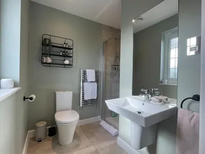 a bathroom with a sink and a toilet and a shower at Luxury 3 Bedroom Home - 15mins to Birkdale Open in Formby