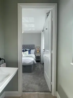 a bedroom with a bed and a white door at Luxury 3 Bedroom Home - 15mins to Birkdale Open in Formby