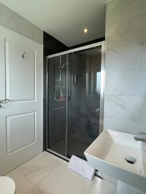 a bathroom with a shower and a sink and a toilet at Luxury 3 Bedroom Home - 15mins to Birkdale Open in Formby