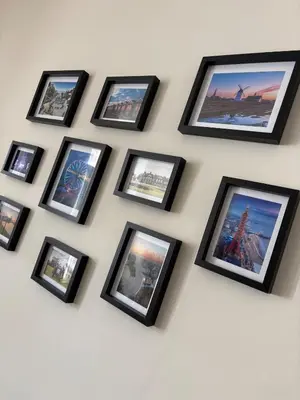 a group of framed pictures on a wall at Beautiful 2 bedroom house in the heart of Lytham in Lytham St Annes