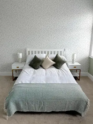 a bedroom with a white bed with two night stands at Beautiful 2 bedroom house in the heart of Lytham in Lytham St Annes