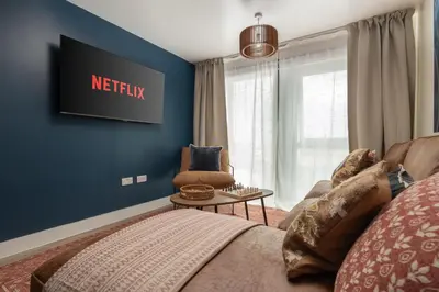 a living room with a couch and a chair at Boutique Escape The Tabac Rooms By Casaco in Liverpool