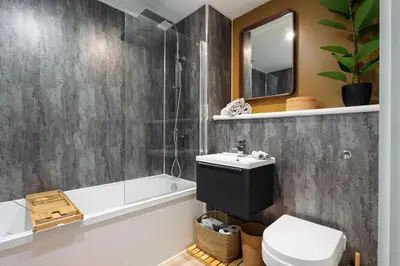 a bathroom with a sink and a tub and a toilet at Boutique Escape The Tabac Rooms By Casaco in Liverpool