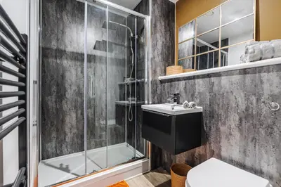 a bathroom with a shower and a toilet and a sink at Boutique Escape The Tabac Rooms By Casaco in Liverpool