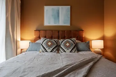 a bedroom with a large bed with two lamps at Boutique Escape The Tabac Rooms By Casaco in Liverpool