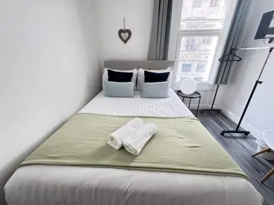 a bedroom with a bed with two towels on it at Bold Street Studio II in Liverpool