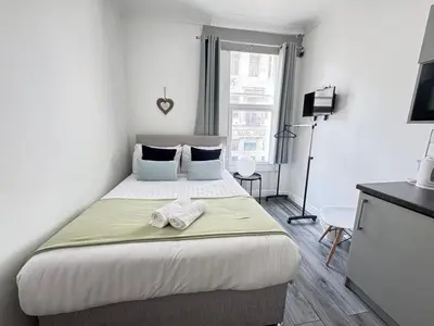 a bedroom with a bed with a towel on it at Bold Street Studio II in Liverpool
