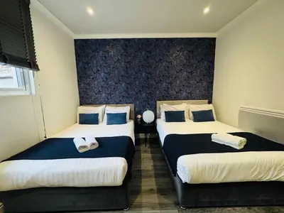 a room with three beds with blue and white at Bold Street Studio IV in Liverpool