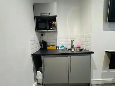 a small kitchen with a sink and a microwave at Bold Street Studio IV in Liverpool
