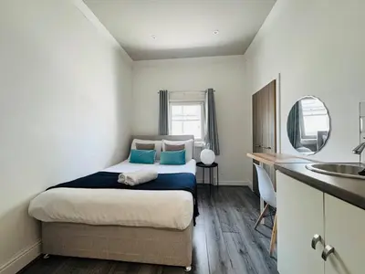 a bedroom with a bed and a sink in it at Bold Street Studio VIII in Liverpool