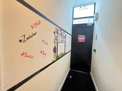 a hallway with a door with graffiti on the wall at Bold Street Studio VIII in Liverpool