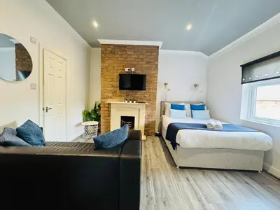 a bedroom with a bed and a fireplace at Bold Street Studio VI in Liverpool