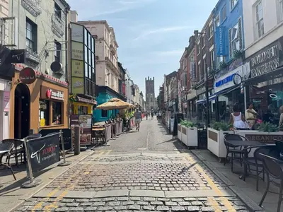 an empty city street with tables and chairs and buildings at Bold Street Studio VI in Liverpool