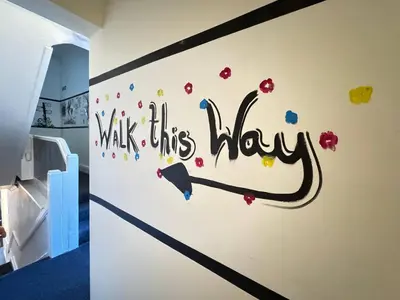 a room with a wall with the words walk this way on it at Bold Street Studio VII in Liverpool
