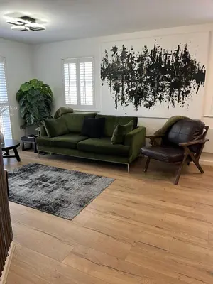 a living room with a green couch and a rug at 2 Bed Modern Apartment in Haydock