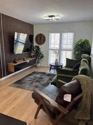 a living room with a couch and a chair at 2 Bed Modern Apartment in Haydock