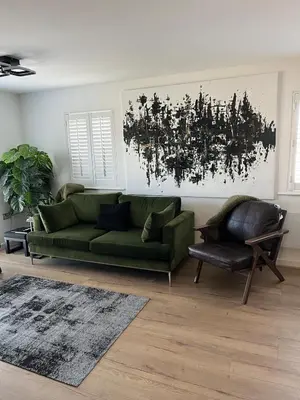 a living room with a green couch and a chair at 2 Bed Modern Apartment in Haydock