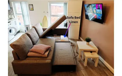 a living room with a couch and a tv at Lodginet Stays - County Cosy - 1BR Flat 2 in Liverpool
