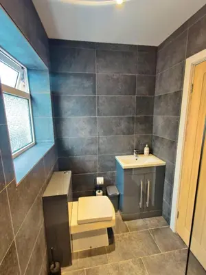 a bathroom with a toilet and a sink at Chic 2-Bed Loft Bungalow, Cleveleys, Near Beach in Blackpool