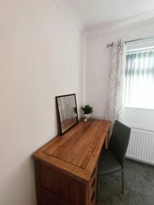 a wooden desk in a room with a chair at Chic 2-Bed Loft Bungalow, Cleveleys, Near Beach in Blackpool