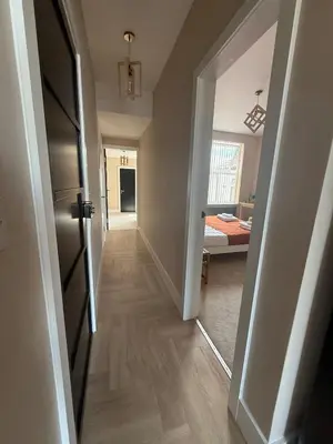 a hallway with a door open to a room at Stylish and Bright 2 Bedroom Flat Free Parking in Wallasey