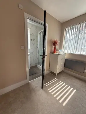 an empty room with a door leading to a bathroom at Stylish and Bright 2 Bedroom Flat Free Parking in Wallasey