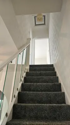 a staircase in a building with black stairs at A home away- 2 bedrooms in Saint Helens