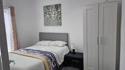 a bedroom with a bed and a picture on the wall at A home away- 2 bedrooms in Saint Helens