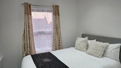 a bedroom with a bed and a window at A home away- 2 bedrooms in Saint Helens
