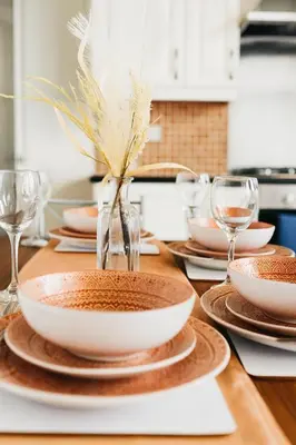 a table with plates and wine glasses on it at Cosy Two-Bedroom House in Ormskirk in Pemberton