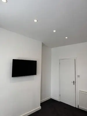 a room with a flat screen tv on a wall at Blackpool Abode - Suites by the Sea in Blackpool