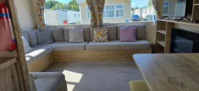 a living room with a couch and a table at Lakeland leisure park sleeps up to 8 in Cark
