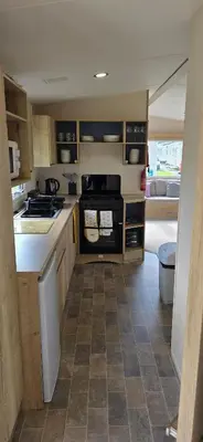 a kitchen with a sink and a stove at Lakeland leisure park sleeps up to 8 in Cark