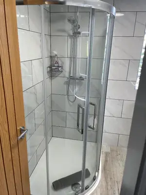 a shower with a glass door in a bathroom at Ulverstons little gem - Sleeps 2 - Free Parking in Ulverston