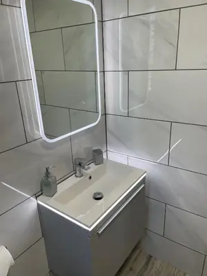 a white bathroom with a sink and a mirror at Ulverstons little gem - Sleeps 2 - Free Parking in Ulverston