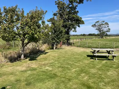 a picnic table in the middle of a field at Ulverstons little gem - Sleeps 2 - Free Parking in Ulverston