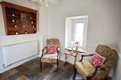 a living room with two chairs and a window at 4 Bed Retreat-Sleeps 7-Parking-Garden-Lake Views in Bolton
