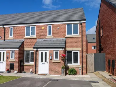 a brick house with a white door at Beach House Seaside Dunes in Lytham St Annes