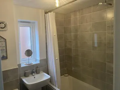 a bathroom with a sink and a shower at Beach House Seaside Dunes in Lytham St Annes