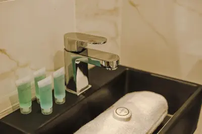 a bathroom sink with a faucet and a towel at Onslow House - Air Host & Stay - 5 bed, Sleeps 14 in Liverpool